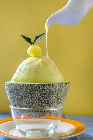 Bingsu - Korean shaved ice dessert with sweet toppings with fresh melonの写真素材
