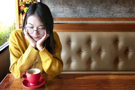 Cute asian woman in the cafe with hot coffee cupの写真素材