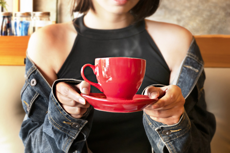 Cute asian woman in the cafe with hot coffee cupの写真素材