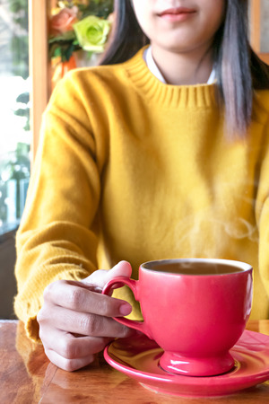 Cute asian woman in the cafe with hot coffee cupの写真素材