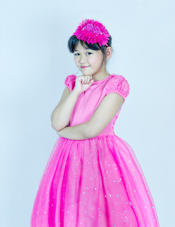 Portrait of asian little  girl in pink dressの写真素材
