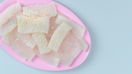 top view raw squid sliced on pink plateの写真素材