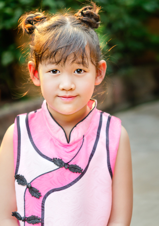 Portrait of asian little  girl in pink dressの写真素材