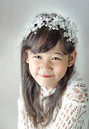 Portrait of asian little  girl in white dressの写真素材