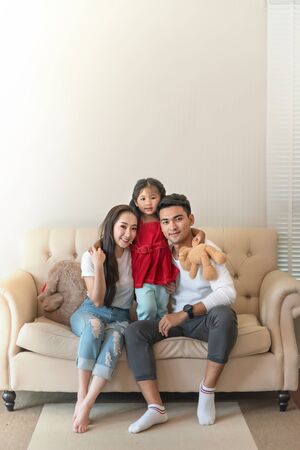 Young happy family at home smiling at cameraの写真素材