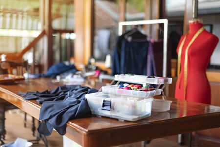 sewing tools and reels of color thread on table. Handmade clothes dressmaking and sewing Concept