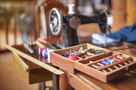 sewing tools and reels of color thread on table. Handmade clothes dressmaking and sewing Concept