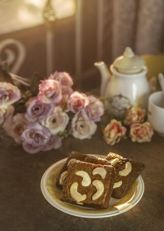 Piece of chocolate cashew nut cake on plate over wooden tableの写真素材