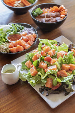 salmon fish fillet served with fresh vegetables on dish, set of japanese style seafood dishesの写真素材