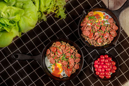 fried eggs and sliced chinese sausage, vietnamese sausage served with fresh vegetables  , asian breakfastの写真素材