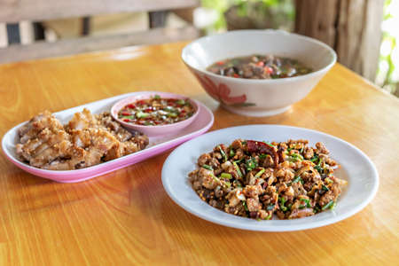 spicy minced meat with mixed vegetables and spicy soup on tableの写真素材