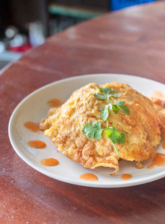 Thai Omelette over steamed rice  on plateの写真素材