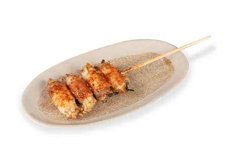 Japanese rolls on a plate with chopsticks isolated on a white backgroundの写真素材