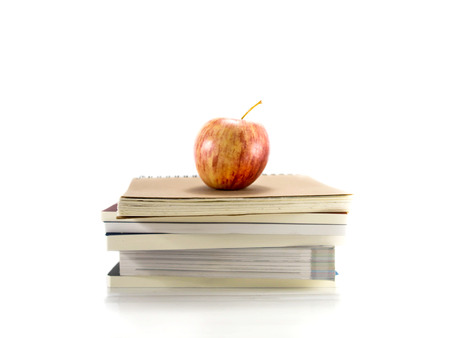 Isolated red apple on the pile of booksの写真素材