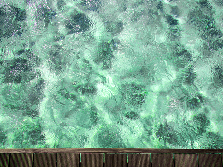 Clear water surface and wooden walk pathの写真素材
