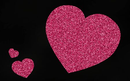 Pink giltter heart on black backgroundの写真素材