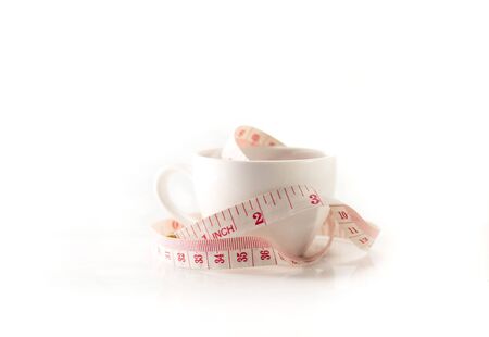 Isolated measure tape in the white cupの写真素材