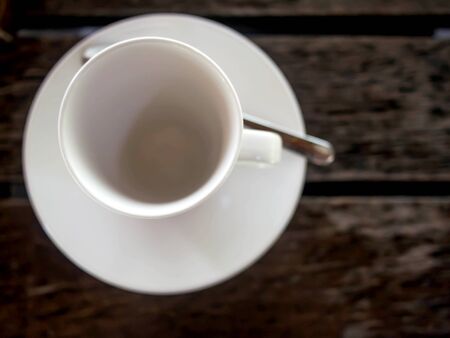 White coffee cup on black wooden table