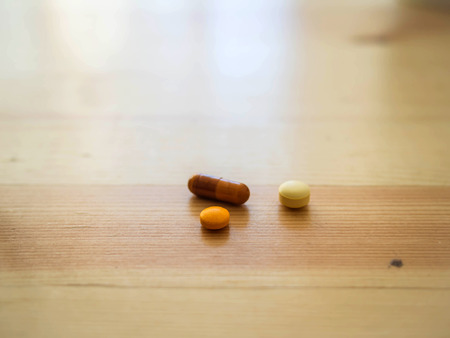 medicine pills and capsule on the wooden tableの写真素材