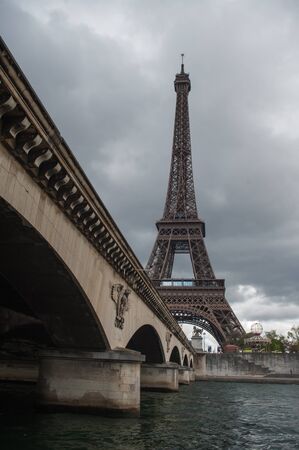 View of the Eiffel Tower from a bridge of the Seine river