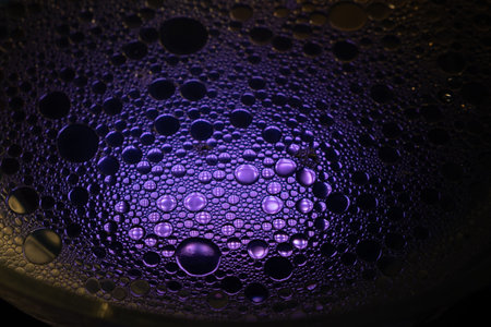 Close up of oil drops on water. background. Abstract blue texture with bubbles