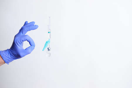 Hand with surgical gloves doing ok symbol on a white backgroundの写真素材