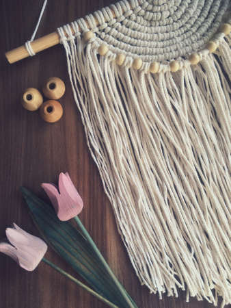 Handmade wooden wall hanging home decor photo with flowers.
