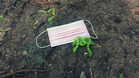 Surgical mask on the ground. Selective focus. Nature.