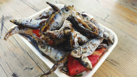 Fried fish meal with paprika on the plate photo