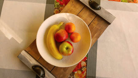 Top view of a plate with fruits on the table in the kitchenの写真素材