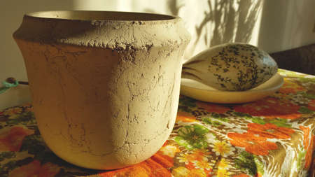 Close up view of clay pot on the table with a flower patternの写真素材