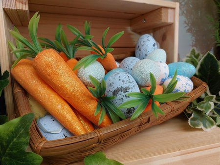 Carrots and Easter eggs, colorful fresh vegetable photo close up. Happy holidays.の写真素材
