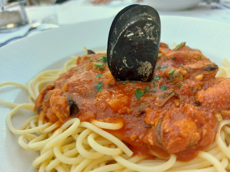 Mussels with tomato sauce and spaghetti. Seafood plate, summer season photo close up.の写真素材