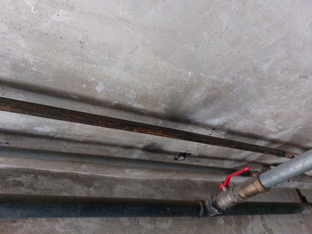 Pipes and water pipes in the basement of a residential building.の写真素材