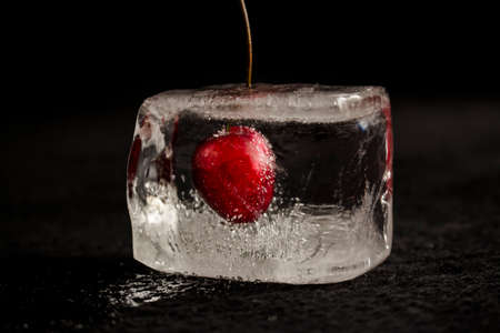 Cherry frozen in a clear ice cubeの写真素材