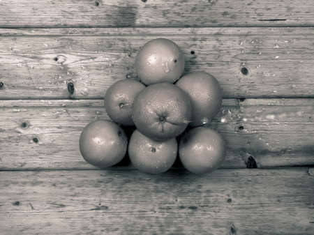 A pile of oranges in black and white