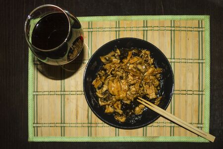 Chinese food plus a glass of red wineの写真素材