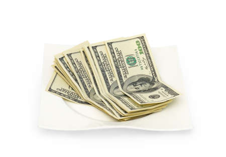 Money scattered on a plate isolated on white backgroundの写真素材