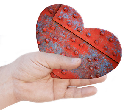 Iron heart in handの写真素材
