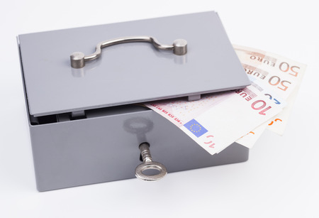Cash box with euro banknotes isolated on white backgroundの写真素材