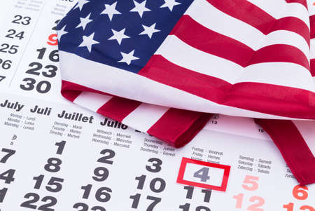Image shows a calender which is marked on the 4th july with US  flagの写真素材