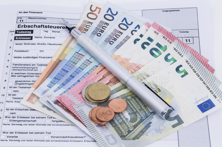 Estate tax form with money and pencilの写真素材