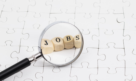 Job hunting concept with magnifying glassの写真素材