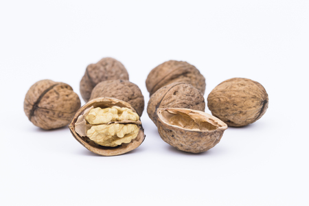 Image shows some walnuts isolated on white background
