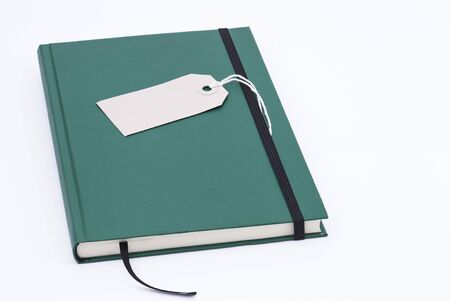 Image shows a green notebook isolated on white background