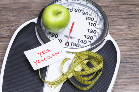 Concept photography for healthy life with apple, bathroom scales and tape measureの写真素材