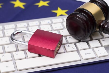 Padlock on laptop with judge hammer