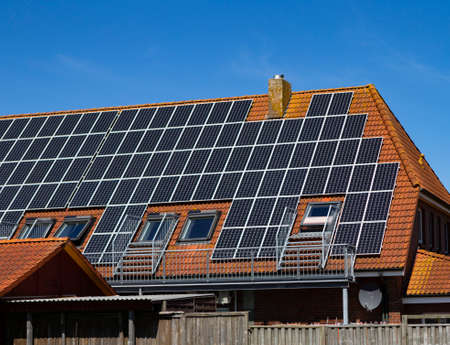 The photo shows a roof on which a photovoltaic system is installedの写真素材
