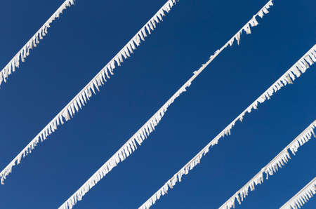 The photo shows white paper garlands with blue sky in Mallorcaの写真素材