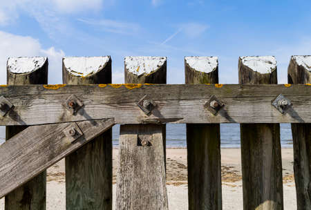 The photo shows a massive wooden fence on the island of Baltrumの写真素材
